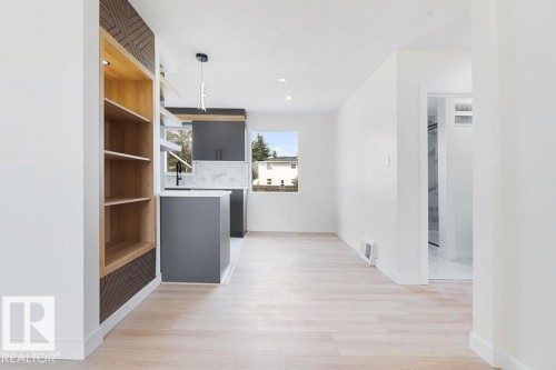 Built-in shelving with decorative paneling and recessed lighting - 12303 131 St Nw Nw, Edmonton, AB 