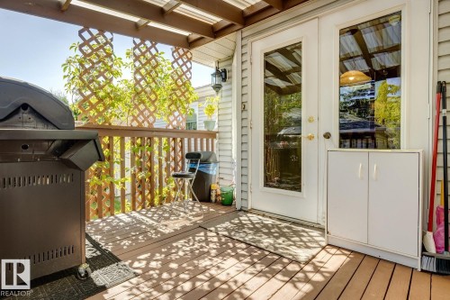 A large 2 tier deck features a cozy sun room - 14243 24 Street Nw, Edmonton, AB 