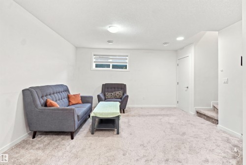 Light-colored wall-to-wall carpeting, white walls, and recessed lighting fixtures - 8024 Orchards Green Green Sw, Edmonton, AB 