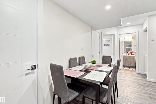 Recessed ceiling lighting, wood-finish flooring, and white walls - 8024 Orchards Green Green Sw, Edmonton, AB 