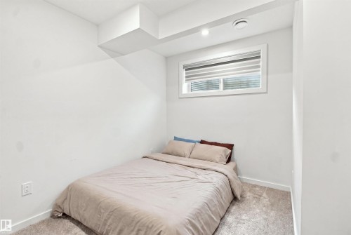 Recessed lighting, window with blinds, baseboard trim, and light-colored carpeting - 8024 Orchards Green Green Sw, Edmonton, AB 
