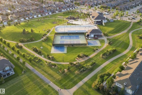 Expansive park area featuring tennis courts, an outdoor rink, walking paths, and green spaces - 8024 Orchards Green Green Sw, Edmonton, AB 