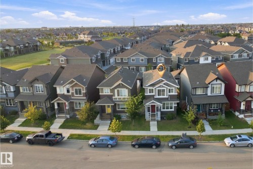 Two-story residence with a gabled roof and light gray siding - 8024 Orchards Green Green Sw, Edmonton, AB 