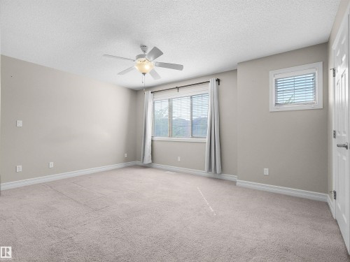 Carpeted flooring, ceiling fan with integrated lighting, window with blinds, additional window with blinds, baseboard trim - 5190 1B Avenue Sw, Edmonton, AB 