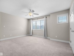 Carpeted flooring, ceiling fan with integrated lighting, window with blinds, additional window with blinds, baseboard trim - 