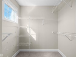 Built-in wire shelving system, multiple wire hanging rods, and a window for natural light - 