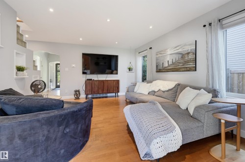 Recessed lighting illuminates the living area with wood-finish flooring - 10726 128 Street Nw, Edmonton, AB 