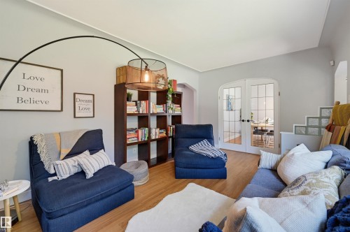 Wood-finish flooring, built-in shelving, glass block architectural details, and arched French doors - 10726 128 Street Nw, Edmonton, AB 