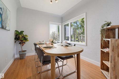 Light wood-finish flooring, corner window configuration, recessed ceiling lighting, and light-toned wall paint - 10726 128 Street Nw, Edmonton, AB 
