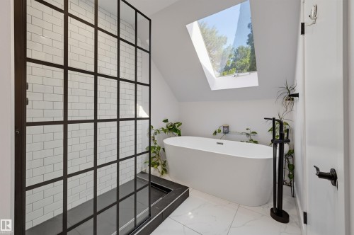 Frameless walk-in shower with grid-patterned glass enclosure and subway tile surround - 10726 128 Street Nw, Edmonton, AB 
