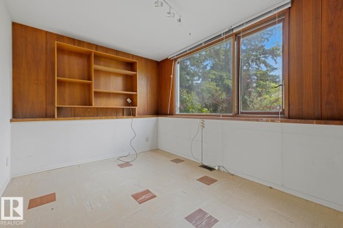 Wood-paneled accent wall with built-in shelving - 7508 139 Street Nw, Edmonton, AB 