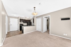 Kitchen featuring dark wood-finish cabinetry, black appliances, and a breakfast bar - 