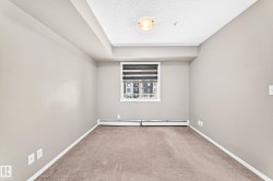 Neutral-toned walls complement the carpeted flooring - 