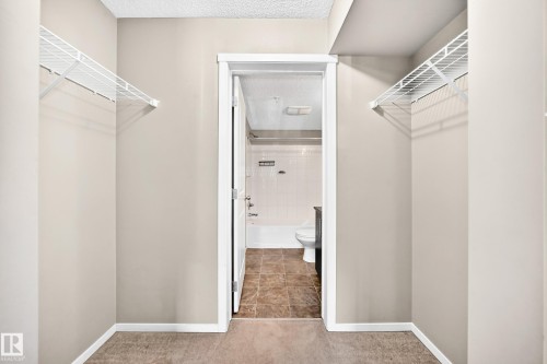 Walk-in closet with wire shelving - #218 5810 Mullen Pl Nw Nw, Edmonton, AB 