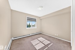 Neutral-toned walls, carpeted flooring, and a single window with blinds - 