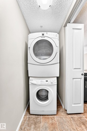 Stacked laundry appliances - #218 5810 Mullen Pl Nw Nw, Edmonton, AB 