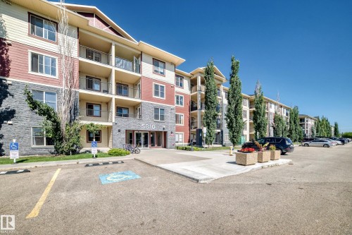Multi-story building featuring stone and siding exterior - #218 5810 Mullen Pl Nw Nw, Edmonton, AB 