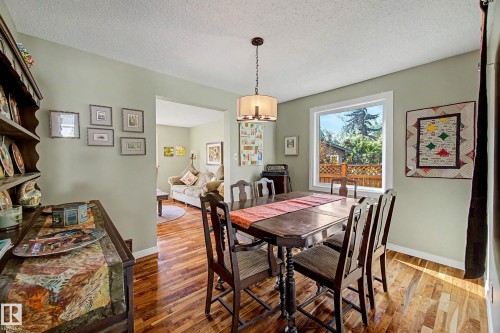 Hardwood-finish flooring, a large picture window, and a built-in display hutch enhance this dining area - 36 Lodgepole Crescent, St. Albert, AB 