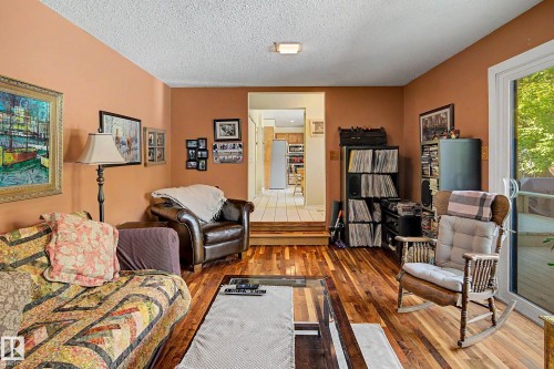 Hardwood flooring, painted walls, sliding glass door, recessed lighting, steps to tiled area - 36 Lodgepole Crescent, St. Albert, AB 