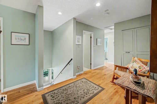 Hardwood flooring throughout, recessed ceiling lighting, light-toned wall paneling, and built-in closet storage - 36 Lodgepole Crescent, St. Albert, AB 