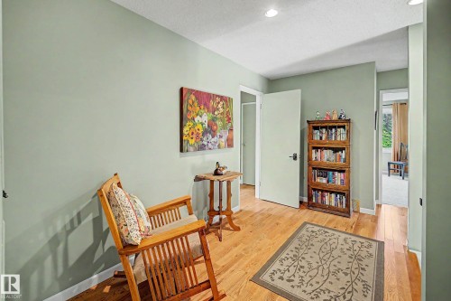 Hardwood flooring, light green painted walls, recessed lighting, and a white interior door - 36 Lodgepole Crescent, St. Albert, AB 