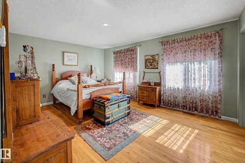 Hardwood flooring complemented by light green wall paint - 36 Lodgepole Crescent, St. Albert, AB 