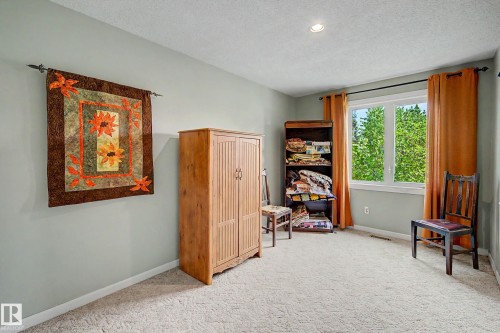 Recessed ceiling lighting, light gray wall paint, window with white trim, and light-colored carpet flooring - 36 Lodgepole Crescent, St. Albert, AB 