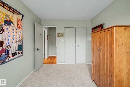 Light gray painted walls, carpeted flooring, and a hallway featuring wood-finish flooring - 36 Lodgepole Crescent, St. Albert, AB 
