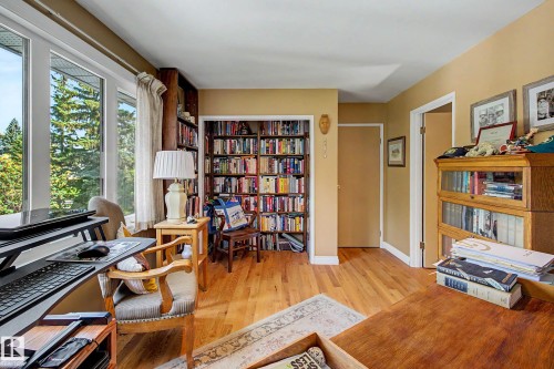 Hardwood flooring throughout, built-in shelving, large windows with exterior scenery, and light-toned wall finishes - 36 Lodgepole Crescent, St. Albert, AB 