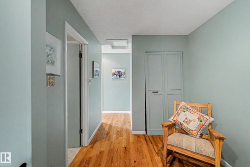 Hardwood-finish flooring, built-in storage cabinet, and light-toned wall paint - 36 Lodgepole Crescent, St. Albert, AB 