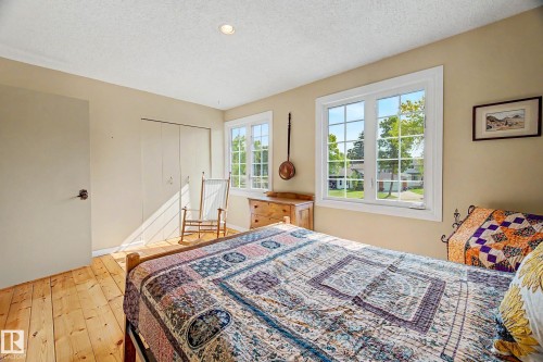 Wood-finish flooring, recessed lighting, and a white trim window with grids - 36 Lodgepole Crescent, St. Albert, AB 