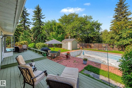 Multi-level wood deck, paver patio, in-ground pool, storage shed, and mature trees - 36 Lodgepole Crescent, St. Albert, AB 