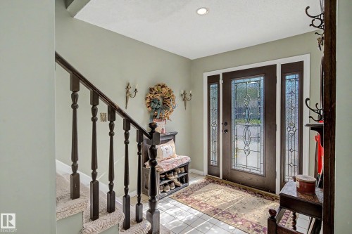 Entry foyer with leaded glass front door and sidelights, recessed lighting, and tile flooring - 36 Lodgepole Crescent, St. Albert, AB 