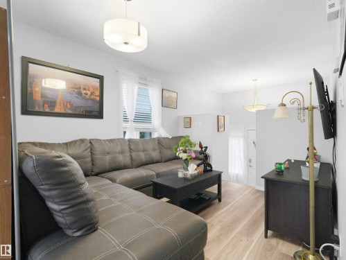 Light wood-finish flooring with white walls - 15511 45 Street Nw, Edmonton, AB 