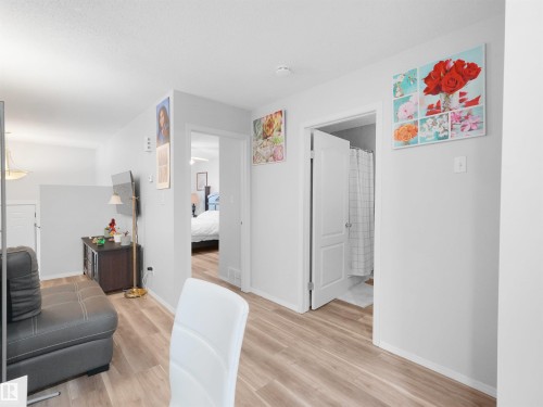Wood-finish flooring throughout, white interior doors, and light neutral wall colors - 15511 45 Street Nw, Edmonton, AB 