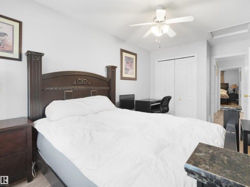 Wood-finish flooring, ceiling fan, and bi-fold closet doors - 15511 45 Street Nw, Edmonton, AB 