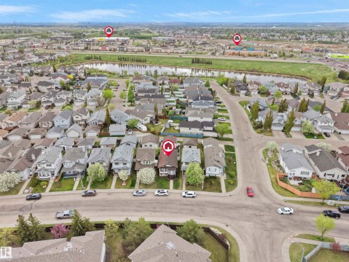 Residential neighborhood with a curved street layout, mature trees, and a visible water body - 15511 45 Street Nw, Edmonton, AB 