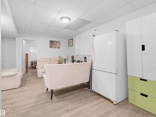 Recessed lighting, wood-finish flooring, white paneled ceilings, and white appliances - 15511 45 Street Nw, Edmonton, AB 