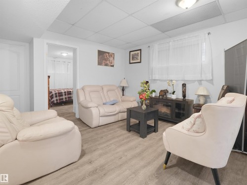 Wood-finish flooring with a drop ceiling and recessed lighting - 15511 45 Street Nw, Edmonton, AB 
