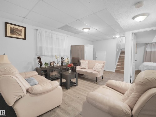 Recessed lighting, wood-finish flooring, drop ceiling, electric fireplace, and a light-filled interior - 15511 45 Street Nw, Edmonton, AB 