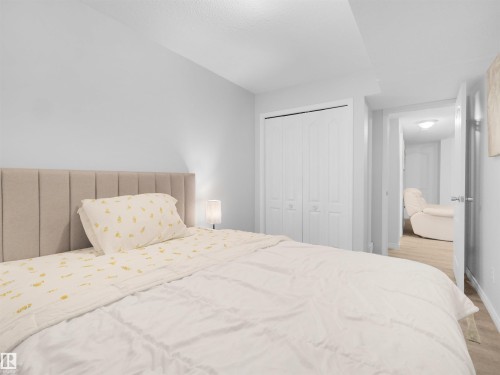 Recessed lighting, wood-finish flooring, and white paneled bi-fold closet doors - 15511 45 Street Nw, Edmonton, AB 