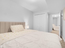Recessed lighting, wood-finish flooring, and white paneled bi-fold closet doors - 