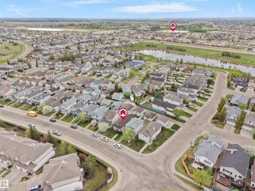 Aerial perspective of a residential neighborhood with a prominent water feature - 15511 45 Street Nw, Edmonton, AB 