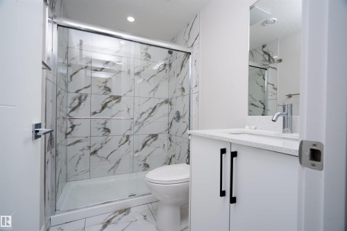 Walk-in shower with clear glass enclosure and large format wall tiling - 904 Knottwood S Nw, Edmonton, AB 