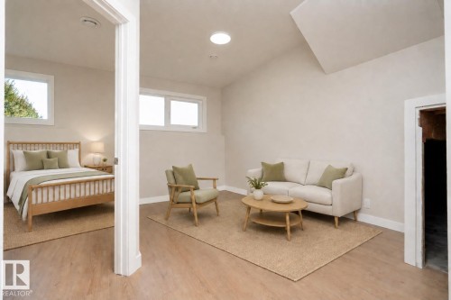 Vaulted ceiling with a skylight, wood-finish flooring, recessed lighting, and multiple windows AI VIRTUAL STAGING - 904 Knottwood S Nw, Edmonton, AB 