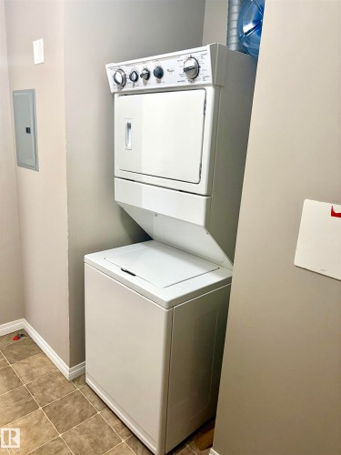 Stacked laundry appliances with a top-load washer and front-load dryer - #1304 9363 Simpson Dr Nw, Edmonton, AB 