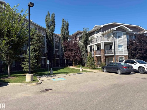 Exterior features include light gray siding, stone accents, and private balconies - #1304 9363 Simpson Dr Nw, Edmonton, AB 