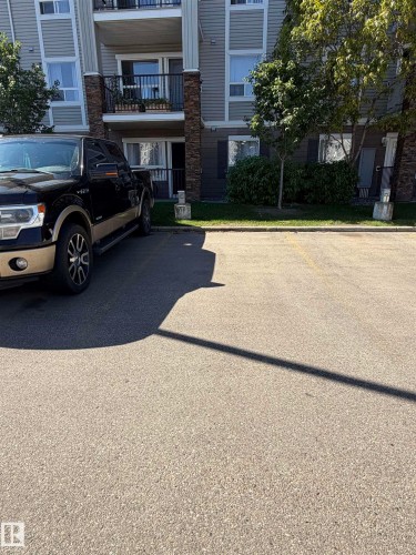 Building exterior with horizontal siding, stone accents, and private balcony - #1304 9363 Simpson Dr Nw, Edmonton, AB 