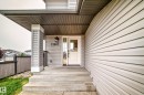 Light-colored siding exterior featuring a covered entryway with concrete steps - 13005 162A Avenue Nw, Edmonton, AB  - Outdoor With Exterior 