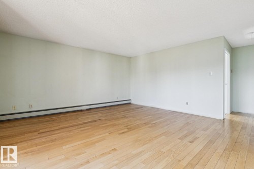 Light wood-finish flooring throughout - #905 9929 113 St Nw, Edmonton, AB 